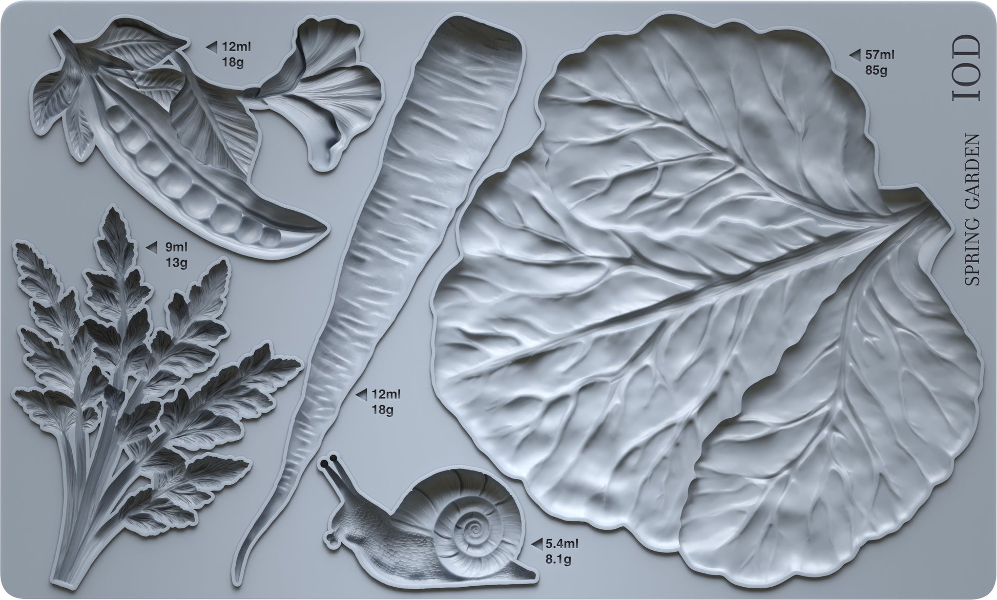 Grey silicone Spring Garden mould from Iron Orchid Designs showing a cabbage leaf, a carrot, carrot tops, a pea pod and a snail