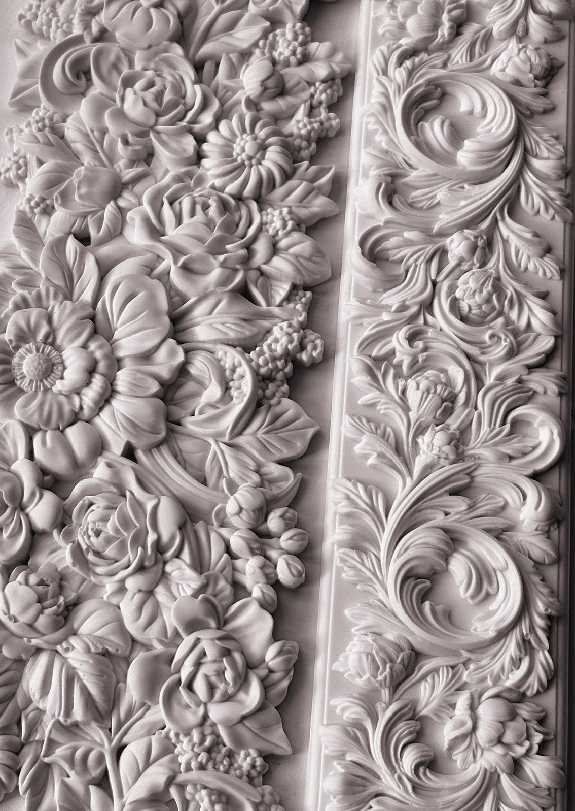 A close up photograph of the beautiful intricately designed flowers from Iron Orchid Designs Trimmings 4 mould. The flowers are white clay