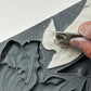 Close-up of a hand using a tool to shape air dry clay in the Iron Orchid Designs Tulips mould