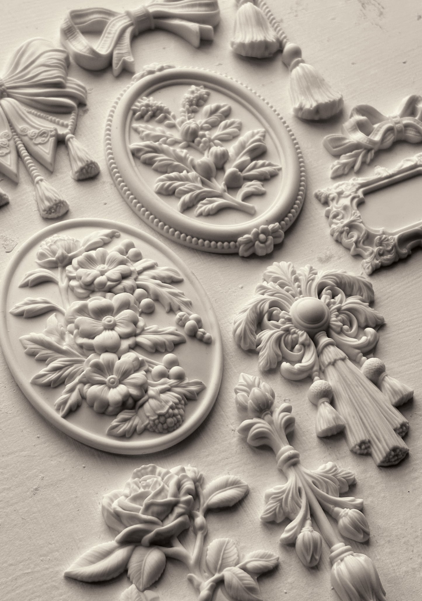 White clay castings from Iron Orchid Designs Victoriana mould on a white background