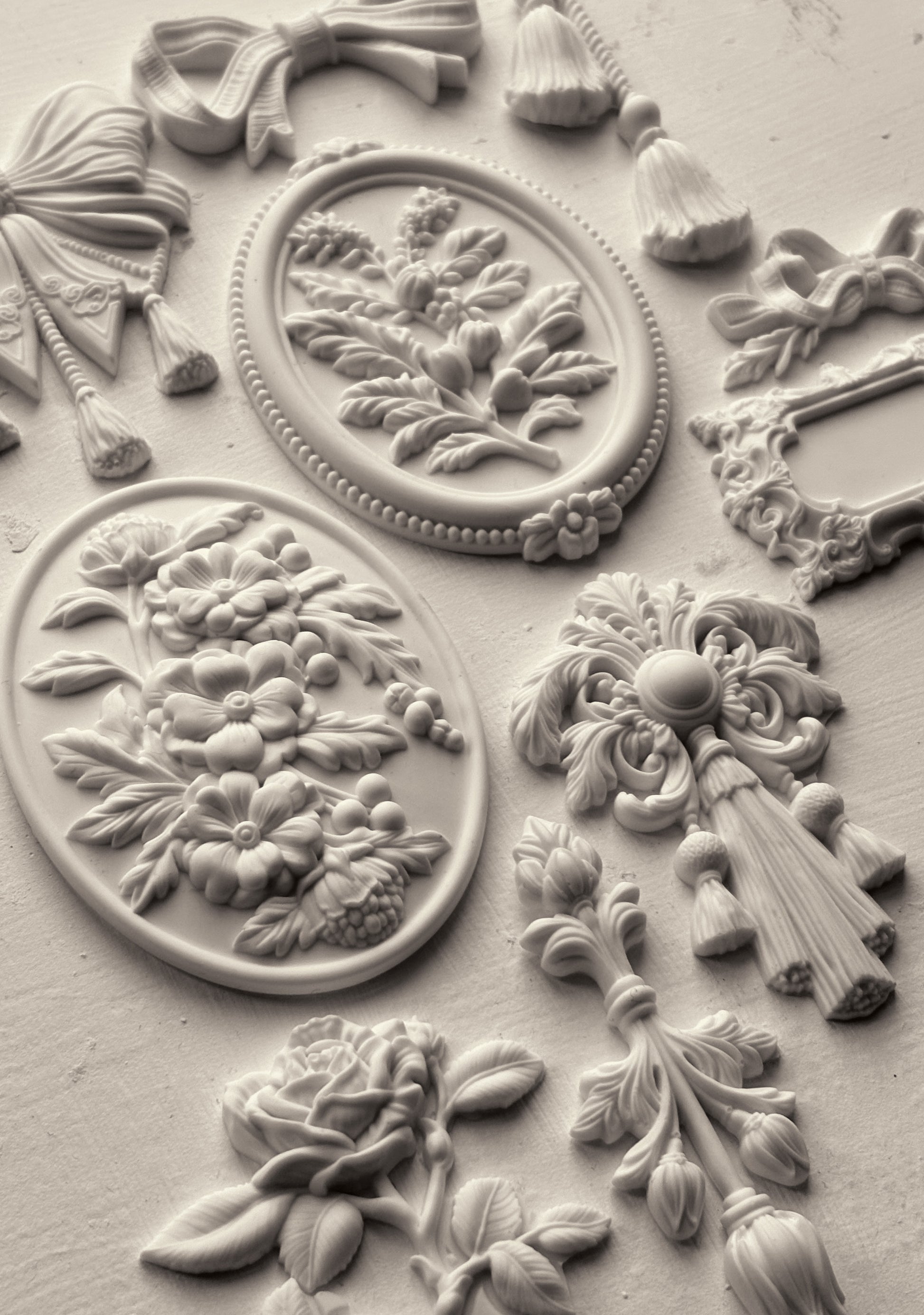White clay castings from Iron Orchid Designs Victoriana mould on a white background