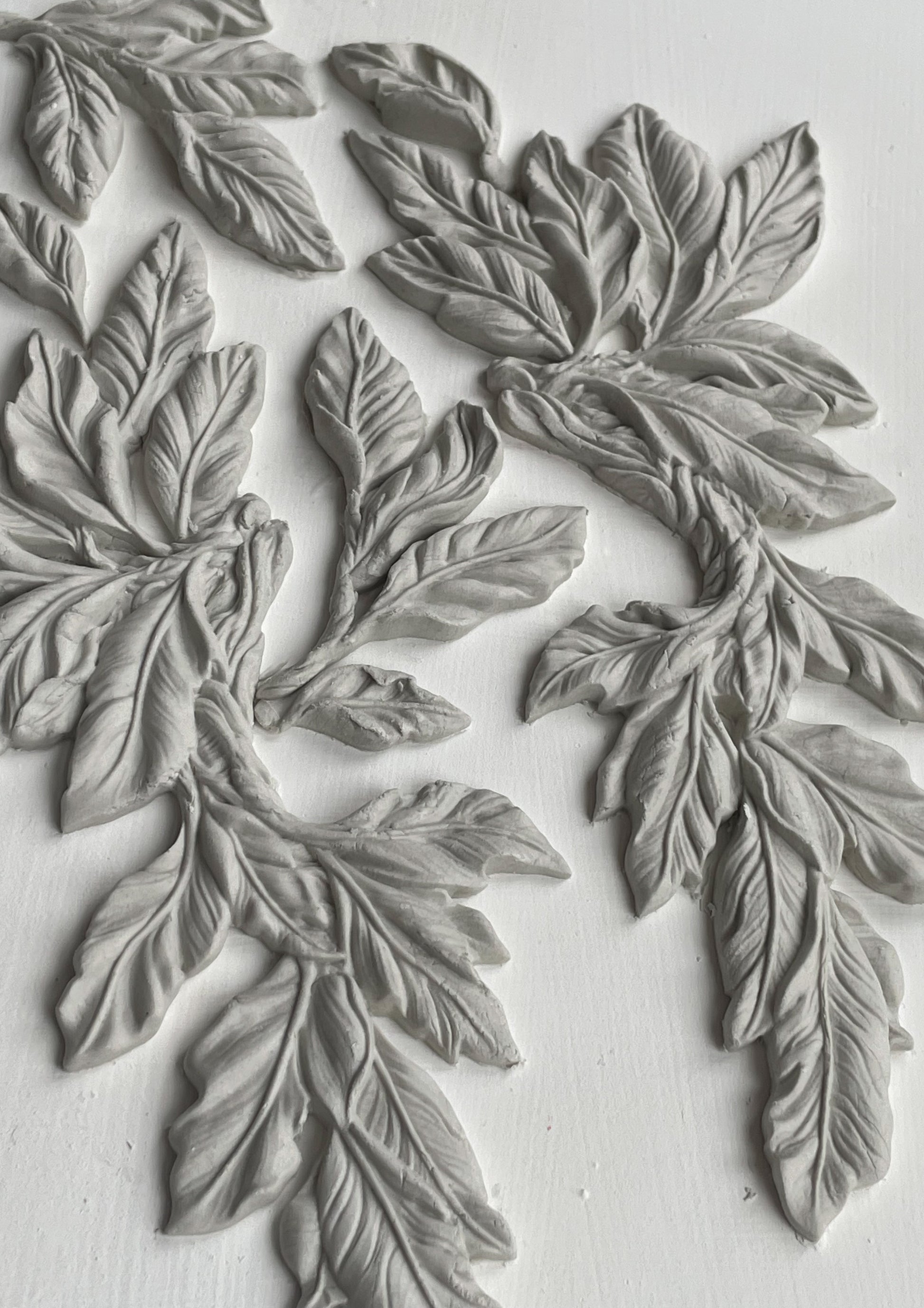 A close up image of white castings on a white background from Iron Orchid Designs Viridis mould