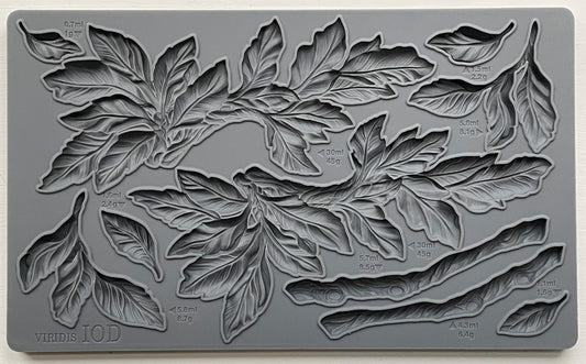 A gray silicone craft mould from iron Orchid Designs featuring a design of leaves and branches.