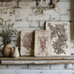 Decorative wooden boards with floral arrangement against a rustic brick wall.
