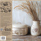Packaging for Iron Orchid Designs Autumn Blessings Stamp showing decorative items including a ceramic jar and a vase with wheat on a wooden surface, with a rustic design theme.