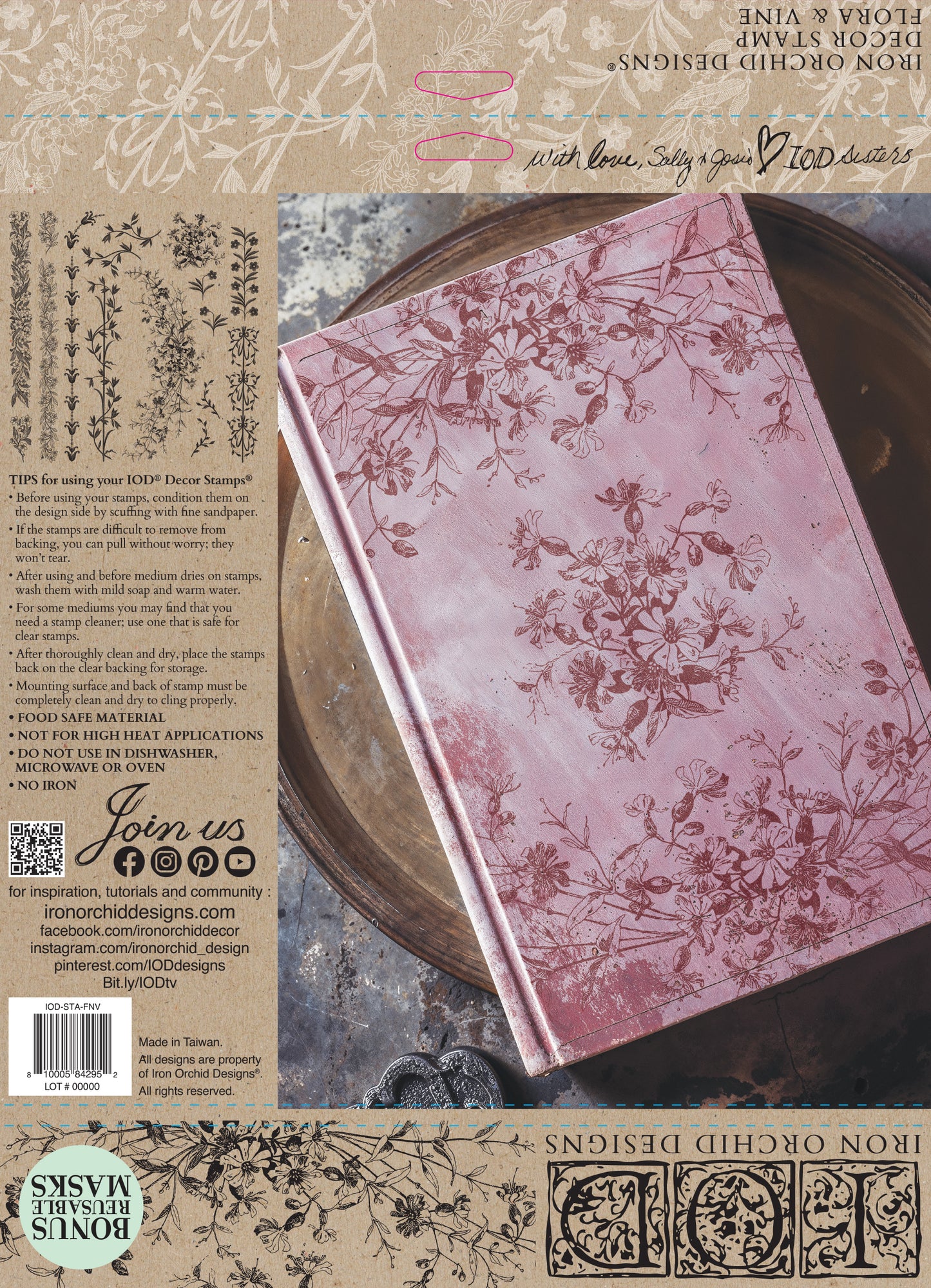 Pink notebook stamped Iron Orchid Designs Flora and Vine with floral patterns on a rustic background