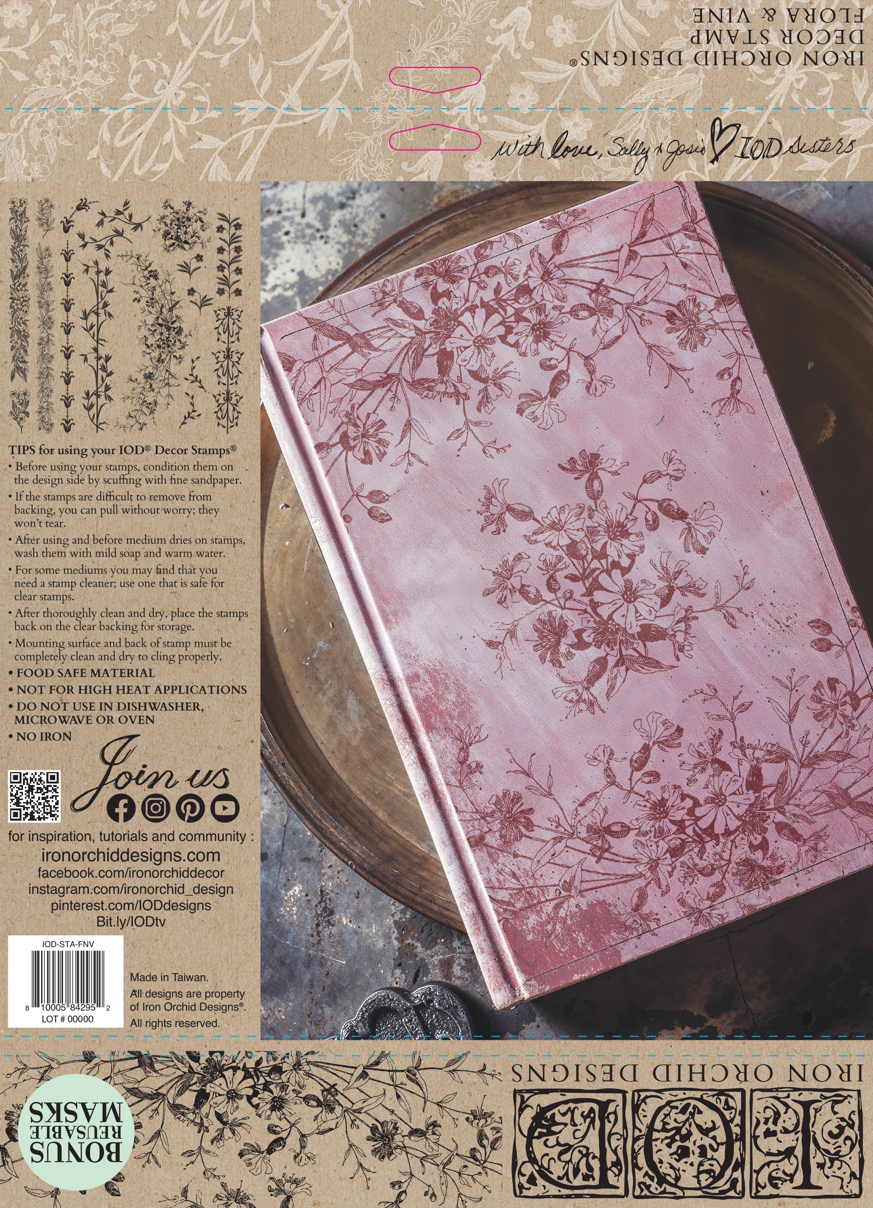 Pink notebook stamped Iron Orchid Designs Flora and Vine with floral patterns on a rustic background