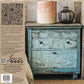 Decorative distressed dresser with candles and a vase, featuring Iron Orchid Designs products.