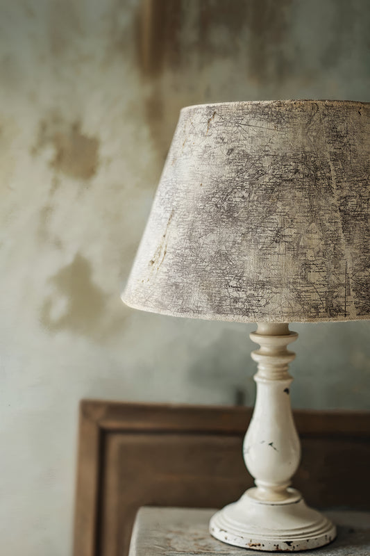 Vintage-style table lamp stamped shade on a wooden surface. The stamp is Orleans by Iron Orchid Designs