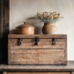 Vintage stamped wooden box with ceramic pot and vase on a rustic surface