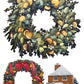 A watercolor-style holiday illustration showing two Christmas wreaths and a small snow-covered house. The top wreath is dense with green foliage and orange-gold ornaments, and the bottom wreath has greenery with red ribbons and orange-gold accents. From Iron Orchid Designs.