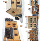A watercolor-style illustration of several small houses in a snowy village, arranged on a white background. The scene includes warm beige and brown buildings with snow-covered roofs, dark chimneys, windows, and evergreen trees with ornaments. From Iron Orchid Designs.
