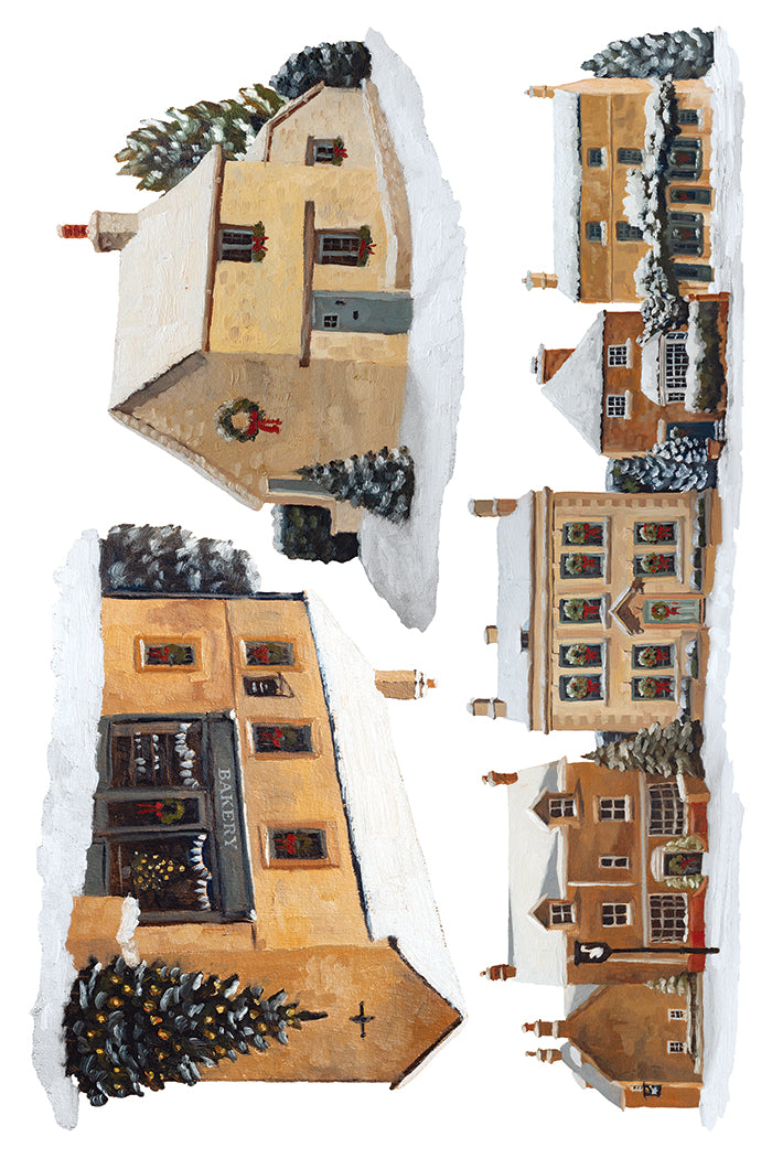 A watercolor-style illustration of several small houses in a snowy village, arranged on a white background. The scene includes warm beige and brown buildings with snow-covered roofs, dark chimneys, windows, and evergreen trees with ornaments. From Iron Orchid Designs.