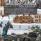 Cover art for 'Iron Orchid Designs Transfer: A Cotswold Christmas' by Marian Parsons, showing a snowy village scene with a horse-drawn sleigh, cottages, trees, and a large decorative title block at the top.