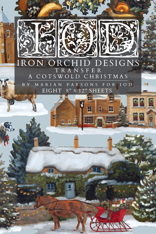 Cover art for 'Iron Orchid Designs Transfer: A Cotswold Christmas' by Marian Parsons, showing a snowy village scene with a horse-drawn sleigh, cottages, trees, and a large decorative title block at the top.