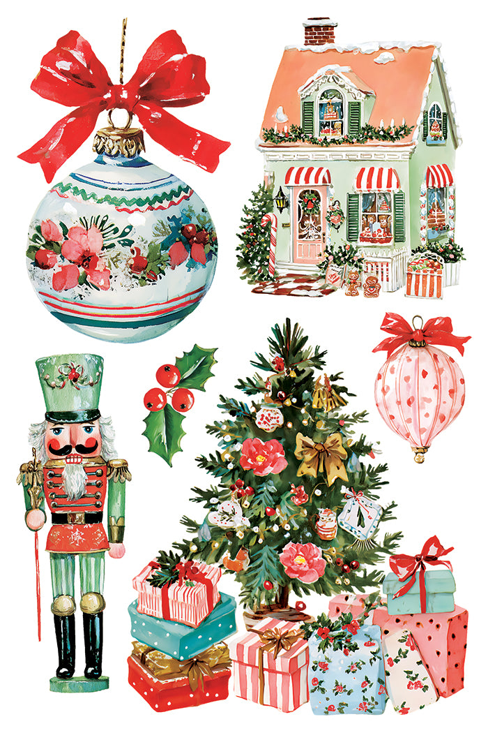A collection of Christmas-themed clipart illustrations on a white background, including a large ornament with a red bow, a decorated house, a nutcracker, a Christmas tree with gifts, and a pink patterned hot air balloon. From Iron Orchid Designs.