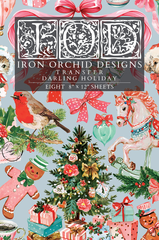 A Christmas-themed retro transfer paper sheet featuring a busy holiday pattern with a robin, carousel horse, ornaments, gifts, gingerbread men, bows, and a central title panel reading 'Iron Orchid Designs Transfer Darling Holiday' and 'Eight 8" x 12" sheets'. From Iron Orchid Designs.