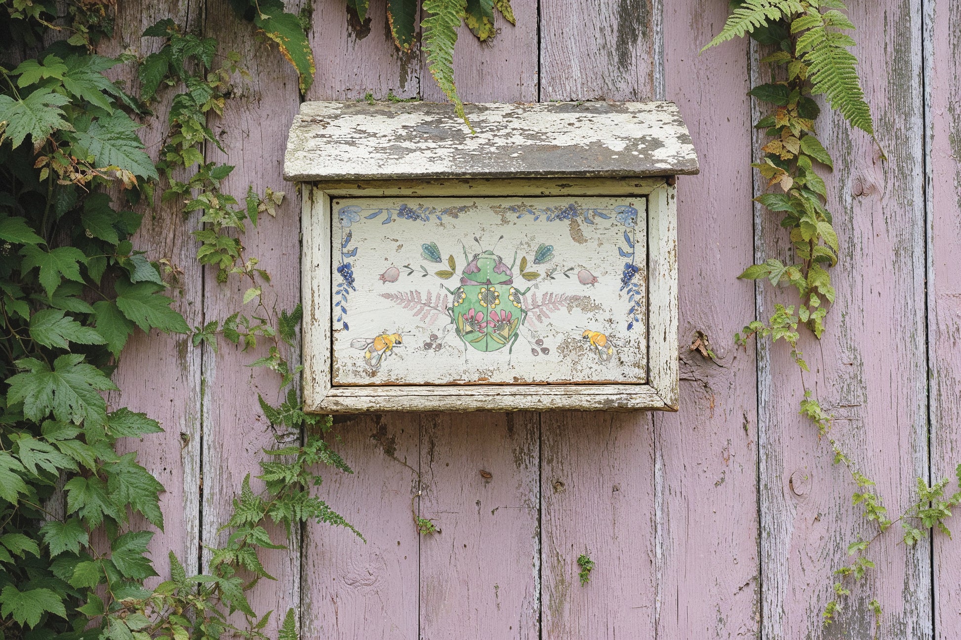 Decorative letterbox on a weathered wooden wall with greenery from Iron Orchid Designs Fern Fables transfer