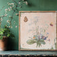 Decorative framed artwork with floral and butterfly design on a green wall from Iron Orchid Designs Marche des Fleurs