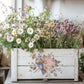 Decorative wooden planter with flowers on a table by Iron Orchid Designs