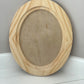 Wooden oval craft blank on a white surface with a grey background by Iron Orchid Designs