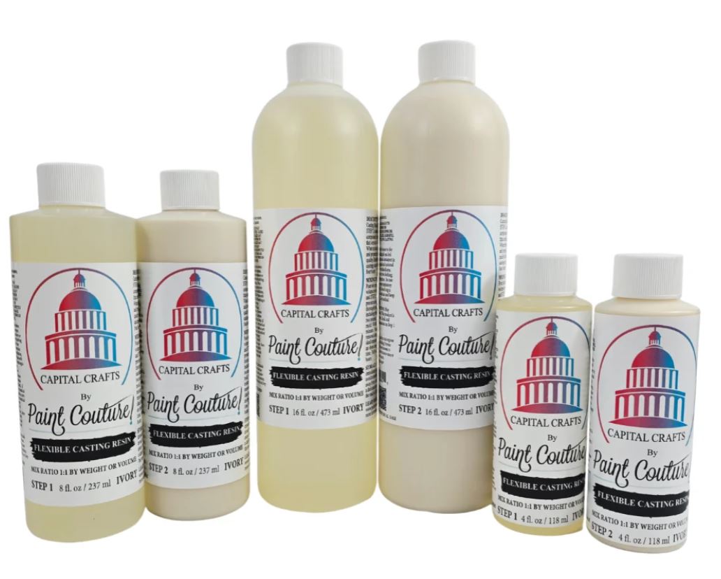 A set of six plastic bottles of Capital Crafts by Paint Couture flexible casting resin in various sizes, arranged against a plain white background.