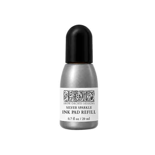 Silver Sparkle Ink Pad Refill by Iron Orchid Designs in a metallic silver bottle with a black cap and white label, centered on a white background.