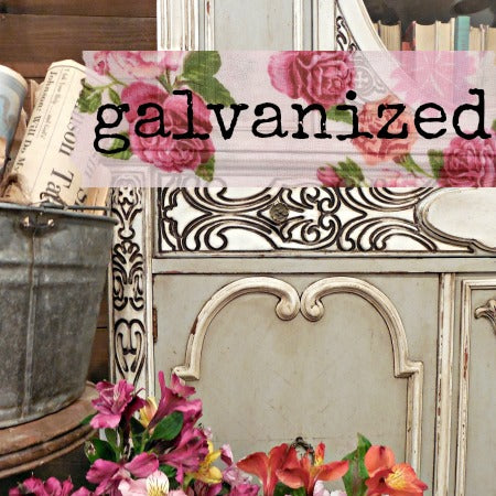 Decorative setting with floral elements and a 'galvanized' sign.