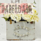 Decorative wooden box with floral design and 'Haberdash' branding.