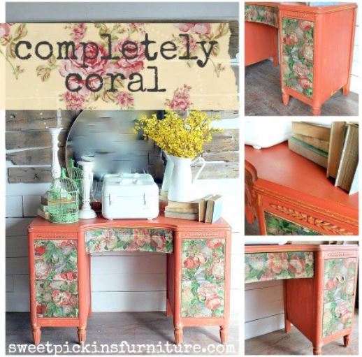 Orange desk with colourful flowery drawers decorated with books, a mirror, a jug of yellow flowers and a bird cage.