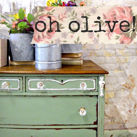 Vintage green dresser with floral decorations and 'oh olive!' text on a rustic background