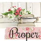Vintage-style scale with flowers on a white wooden background, featuring the brand 'Proper'.