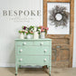 Vintage-style dresser with flowers in a rustic interior setting, featuring the 'Bespoke Collection' by Jami Ray Vintage.