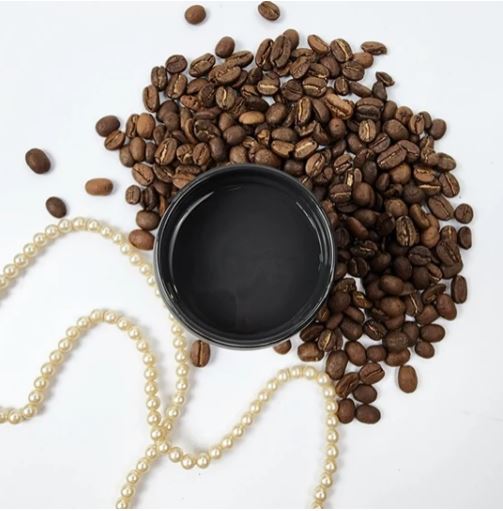 Dark brown paint in a pot surrounded by coffee beans. Paint Couture