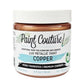 A jar of Paint Couture Lux Metallic Paint in the color Copper, featuring a white lid and a white label with black and light blue text.