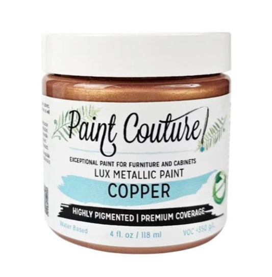 A jar of Paint Couture Lux Metallic Paint in the color Copper, featuring a white lid and a white label with black and light blue text.