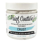 A jar of Paint Couture Textures Crust paint, featuring a white lid and a white label with black and light blue text, set against a plain white background.