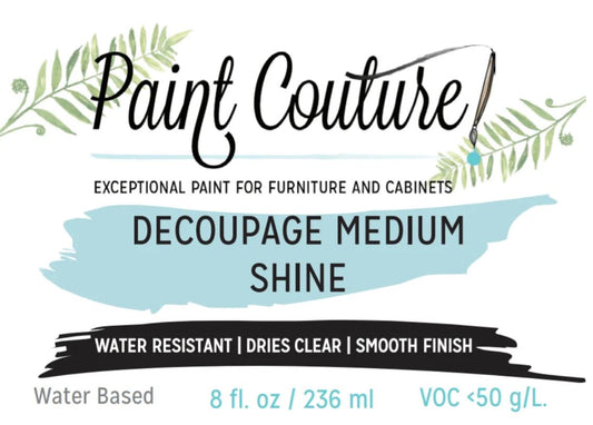 A product label for Paint Couture Decoupage Medium Shine water-based paint, featuring a light blue brushstroke background, black text, and green leaf illustrations on a white background.