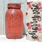 Red mason jar with 'NW Mason' branding next to a decorative sign with 'cherry pie' text and floral design.