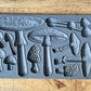 Iron Orchid Designs Toadstool grey Mould laying on a wooden surface
