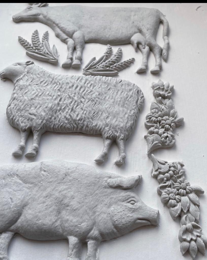 White clay castings from Iron Orchid Designs Village Market Mould showing pig, sheep and cow