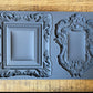 Iron Orchid Designs Frames 2 grey Mould laying on a wooden surface