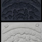 Iron Orchid Designs Swags grey Mould above white clay castings of the mould