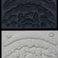 Iron Orchid Designs Swags grey Mould above white clay castings of the mould