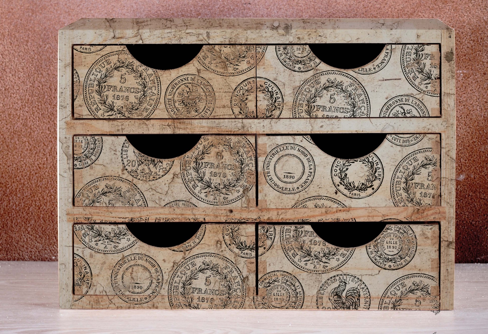 A set of six small wooden drawers decorated with Iron Orchid Designs Antiquities stamps