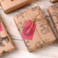 A collection of gifts wrapped with brown paper stamped using Iron Orchid Designs Antiquities stamps