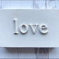 White typography sign spelling love in white letters from Iron Orchid Designs Harper Mould