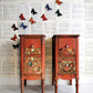 Iron Orchid Designs Millot's Pages Transfer on two small red chest of drawers standing side by side with a pale background.