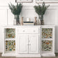 Iron Orchid Designs Millot's Pages Transfer applied to the end sections of a white cupboard with vases of flowers standing on top