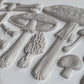 White clay castings from Iron Orchid Designs Toadstool grey Mould laying on a white surface
